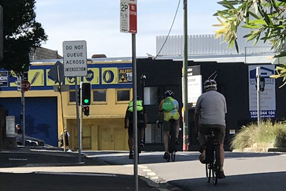 Bike riders coming up to traffic light in Rozelle