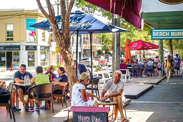 A Better Street has space for people to linger and participate in community life. Traffic is slow and there is seating and shade (Source: Better Streets)